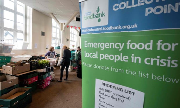 A person collects grocery from a food bank in Bradford, West Yorkshire