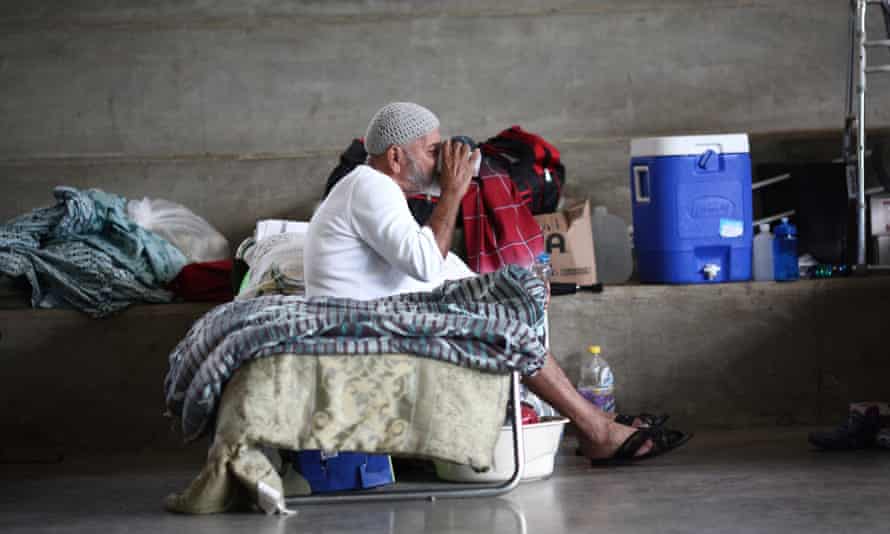 A man who lost his home during Hurricane Maria in September sits on a cot at a school turned shelter in Canovanas.