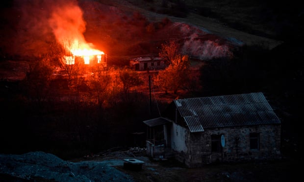 Villagers outside Nagorno-Karabakh set their homes on fire before fleeing to Armenia ahead of a deadline that will see some disputed territory handed over to Azerbaijan as part of a peace agreement