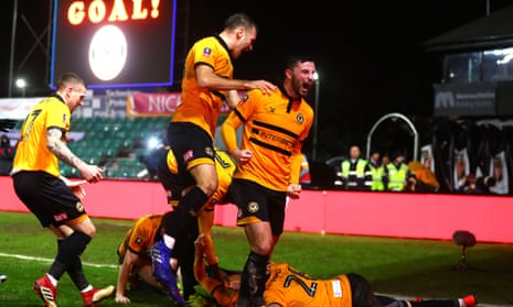 Newport’s players celebrate the goal from Robbie Willmott, early in the second half, that set them en route to another famous victory.