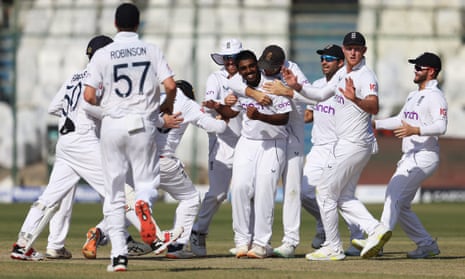 Rehan Ahmed of England is congratulated by teammates after taking his first international wicket.