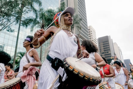 A woman bangs a drum in a celebration marking Black Consciousness Day in Brazil.