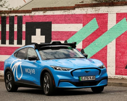 A Wayve autonomous car drives through a residential street in London