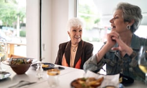 Senior friends having lunch in a restaurant, talking and laughing