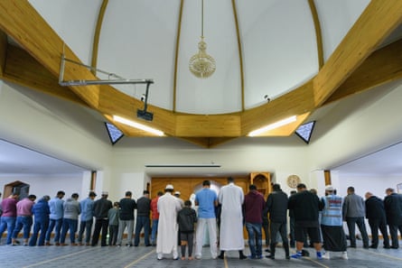 Worshippers are seen praying on freshly laid underlay at Al Noor mosque in Christchurch on Thursday.