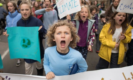 schoolchildren marching through Cambridge city centre during a climate change protest.