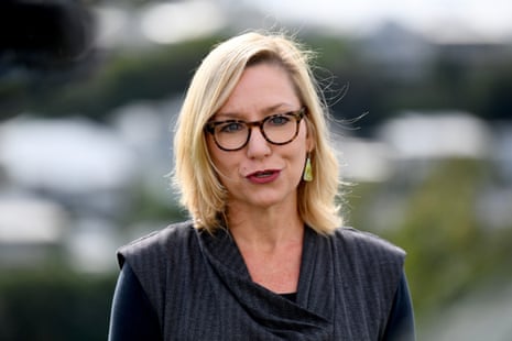 A woman with blond hair and glasses speaks.