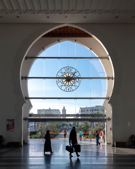 The large glass entrance at the station, with a delicate Arabian motif, looking out at the city.