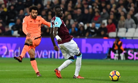 Liverpool’s Mohamed Salah (L) shoots past West Ham United’s Senegalese midfielder Cheikhou Kouyate to score their fourth goal.