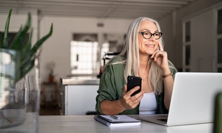 UK pensions: it’s simple to chop charges – and you may save 1000's | Pensions 1 A woman using a laptop and smartphone