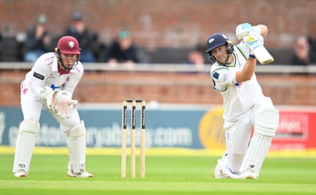Joe Root on the drive for Yorkshire while James Rew keeps wicket