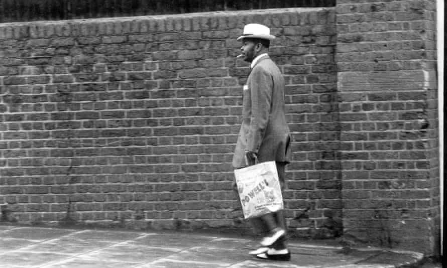 A man fashionably dressed in a zoot suit - wide legs and high waist - in Notting Hill, London, 1968.