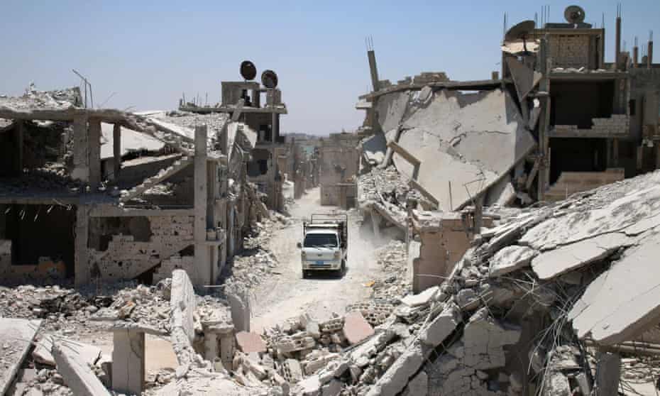 A truck drives down a destroyed street in a rebel-held area of Deraa in July 2017. The Syrian regime retook the province from rebels in July 2018.