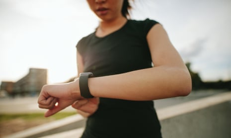 A female runner using a smartwatch
