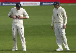 Root watches teammate Stokes holding his stomach.