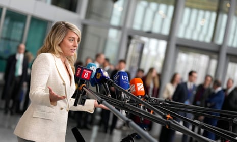 Canada's Foreign Minister Melanie Joly speaks with the media as she arrives for a meeting of NATO foreign ministers at NATO headquarters in Brussels.