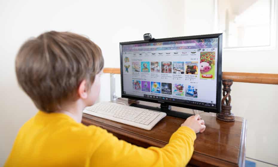 A young boy plays an online game at home.