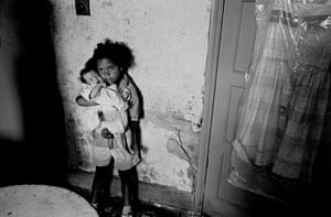 Birmingham, 1970. A young girl with her baby sister in a slum property in Balsall Heath