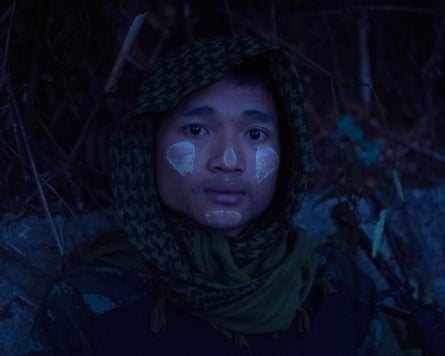 A young rebel, a member of a drone unit, hides along the frontline