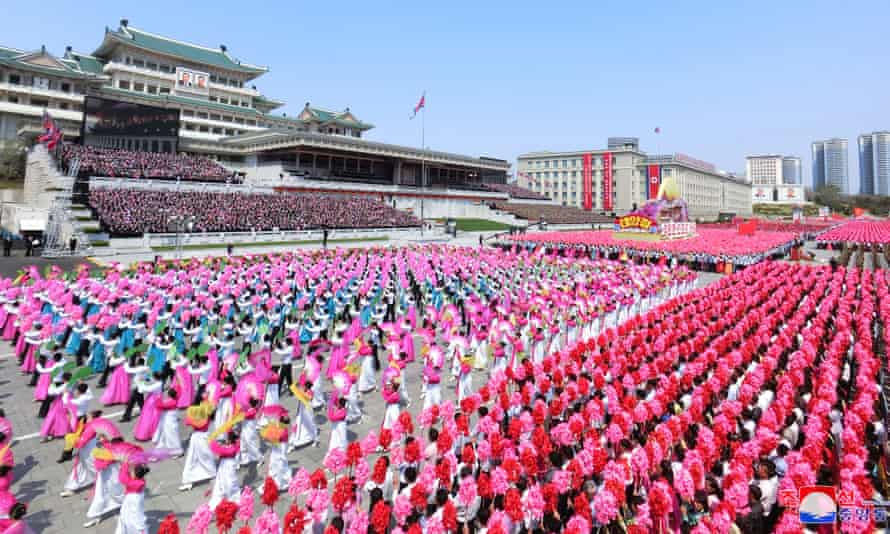 North Koreans march in the centre of Pyongyang to celebrate the 110th birthday of Kim Il-sung.