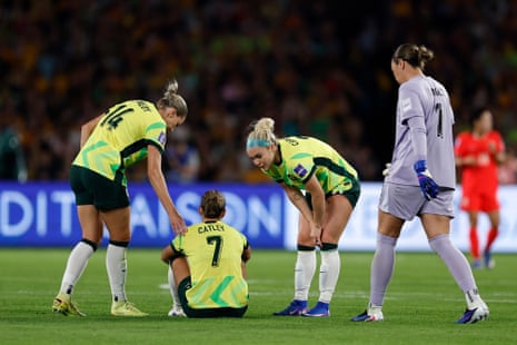 Steph Catley sits on the turf