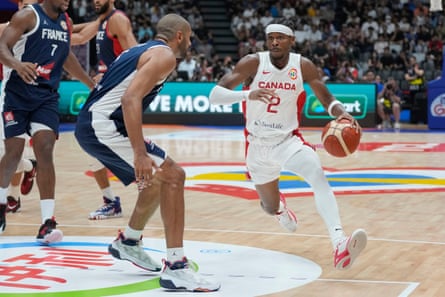 Shai Gilgeous-Alexander, right, dribbles past France forward Nicolas Batum during their Group H matchup in Jakarta.