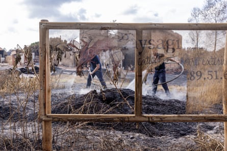 Firefighters tackle a pile of smouldering peat
