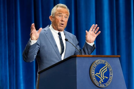 Robert F Kennedy Jr speaks with his hands raised at a lectern