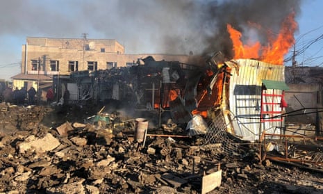 A building burns at a site of a market hit by Russian missiles.
