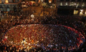 Peoplestand around tributes on Las Ramblas, Barcelona, where 13 people were killed in a terror attack on 17 August.