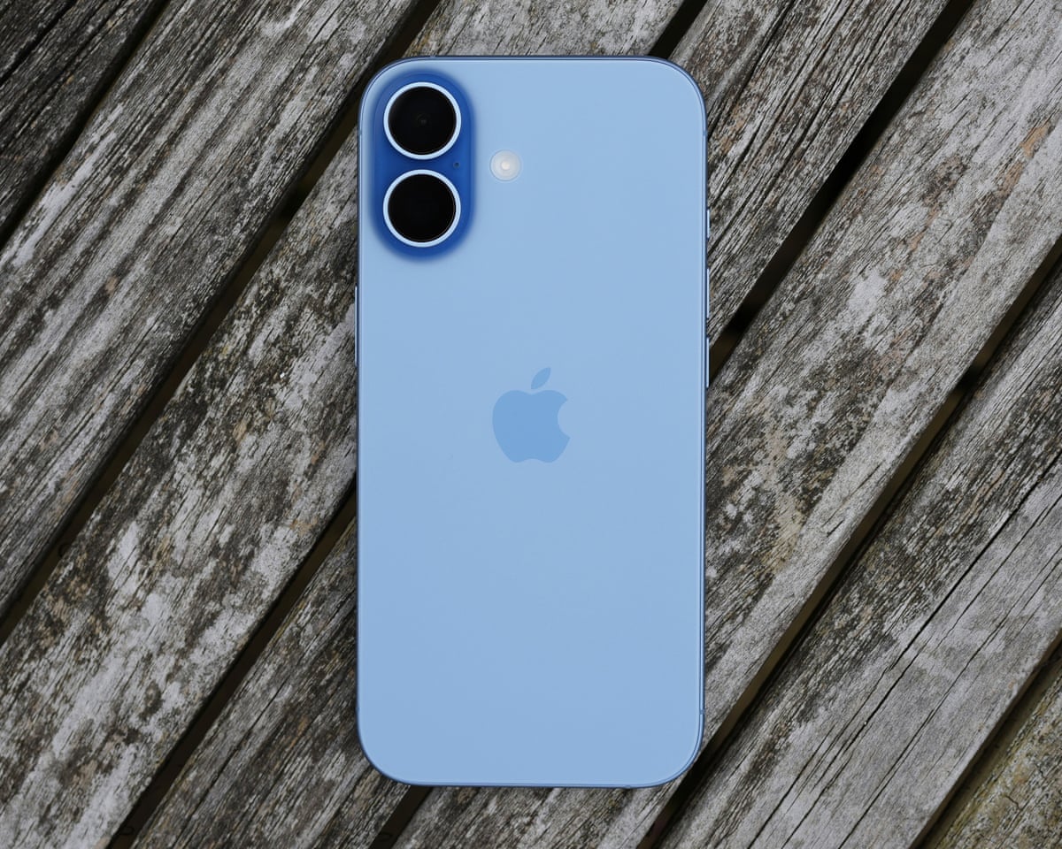 An iPhone on a wooden table outside