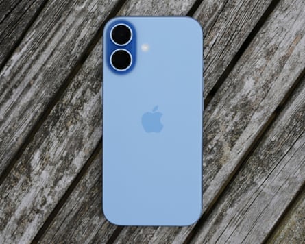 An iPhone on a wooden table outside