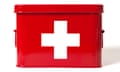 Red first aid kit with white cross