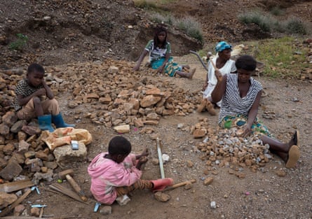 Women and children crush rocks to sell as gravel in Kabwe, Zambia