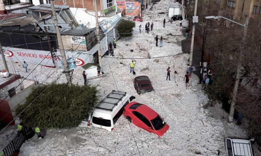 Vehicles buried in hail are seen in the streets in the eastern area of Guadalajara