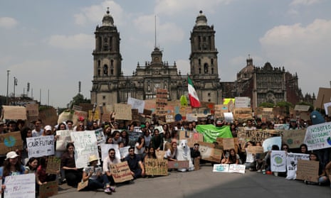 Students pose in front of Metropolitan Cathedral at the main square Zocalo, before they take part in a march demanding action on climate change, in Mexico City, Mexico.