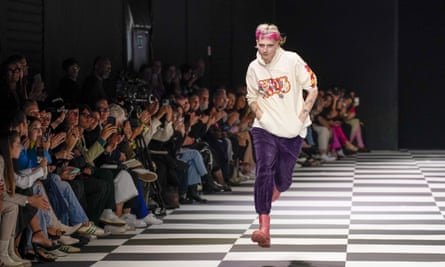 Matty Bovan accepts applause at the end of his Milan show on Sunday.