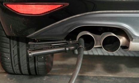 A hose for an emission test is fixed in the exhaust pipe of a Volkswagen Golf  diesel car.
