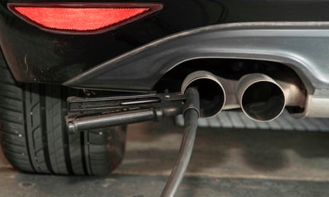 A hose for an emission test is fixed in the exhaust pipe of a Volkswagen Golf 2,0 litre diesel