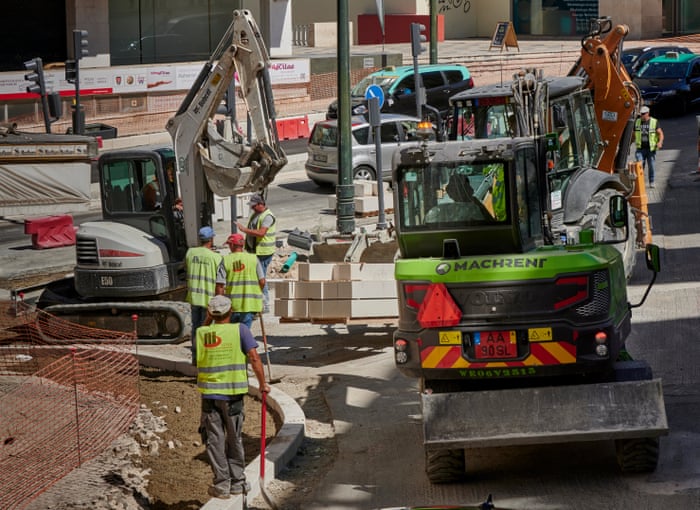 Workers are helped by machinery while remodeling a sidewalk near Praça Espanha on 2 September, 2020 in Lisbon, Portugal. The coronavirus pandemic has not stopped construction activities in Portugal.