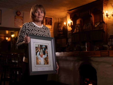 Mary Meaney holds a photograph of her father, Mick Meaney.