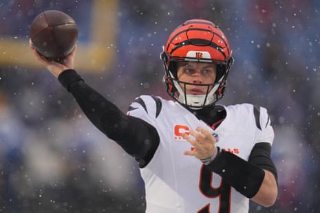Cincinnati Bengals quarterback Joe Burrow throws a warmup pass through the snow