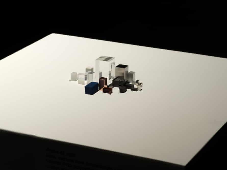 iPhone 4s represented by small cubes and prisms that are clear, black, silver and copper-colored