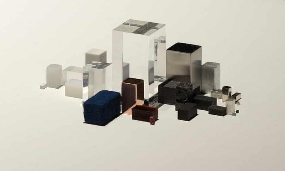 iPhone 4s represented by small cubes and prisms that are clear, black, silver and copper-colored