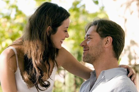 They smile at each other in dappled sunlight