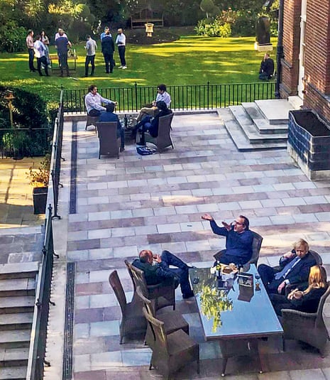Boris Johnson and staff pictured with wine in the Downing Street garden in May 2020.