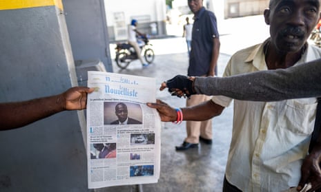 A vendor sells newspapers reporting on the assassination of President Jovenel Moïse in Port-au-Prince
