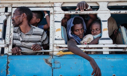 Refugees are transferred by bus from the Hamdayet camp to another Sudanese border camp at Um Rakuba.