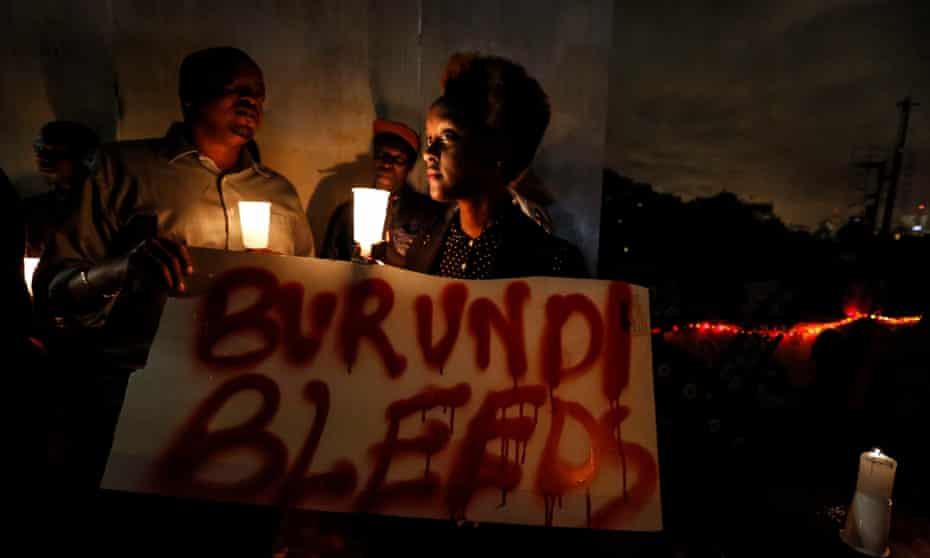 A woman holds a placard reading ‘Burundi bleeds’ during a candlelight vigil calling for peace in the country held last December in the Kenyan capital Nairobi