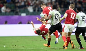 Liam Williams of Wales collides with team mate Dan Biggar in the air.
